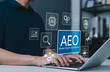 © Supatman - AEO, Answer Engine Optimization Strategy for Digital Marketing Success Concept. Man using laptop with AEO icons representing modern marketing, search optimization, and AI driven content strategies.