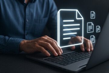 Person typing on laptop with document icons floating above the keyboard in a dark environment