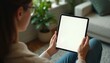 © miss irine - Woman holds Pro with blank white screen, indoors. Modern digital tablet device. Mobile app, online, tech concept for business. Empty display with touchpad. Using apps. Modern design for marketing,