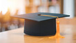 © hardvicore - Black square academic cap on table. Education concept.