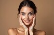 © miss irine - Beautiful brunette woman touches face looking at camera. Natural beauty, skincare, wellness concept. Portrait of happy young caucasian woman. Spa treatment, cosmetology.