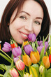 © Nataliya - Portrait of a happy brunette girl with a bouquet of tulips.