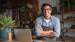 © Riko - Confident hispanic male adult entrepreneur in apron with laptop in cozy store