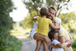 © Halfpoint - A portrait of young family with small children in sunny summer nature.