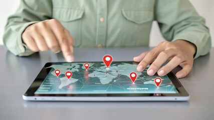 Person using a tablet displaying a world map with red location pins indicating various destinations