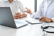 © Freedomz - Professor Doctor consulting with patient discussing something and recommend treatment methods, Presenting results on report, Medicine and health care concept