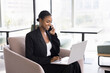 © fizkes - Successful phone negotiations. Smiling confident Black businesswoman working on distance discuss deal with customer by telephone offer advice support to client using electronic documents on notebook