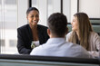 © fizkes - Friendly communication. Relaxed diverse multiethnic office workers team gather at table in cozy cafe chatting having fun discuss successful project results with joy laughter during casual conversation