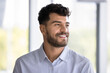 © fizkes - Looking forward to success. Close up headshot portrait handsome bearded young businessman executive look aside with smile feel happiness confidence ready to meet professional challenge with enthusiasm