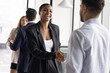© fizkes - Building trust in relationship. Smiling young businesswoman exchange handshake with male client coworker standing in shared space office feel happy to meet grateful for help express respect make deal