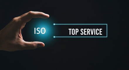 Wall Mural - Human Hand Holding Illuminated ISO Top Service Text Displayed On Dark Background