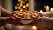 © Olga - Warm holiday pie shared by two people in cozy setting with candlelight and festive background