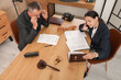 © Pixel-Shot - Lawyers holding meeting at table in office