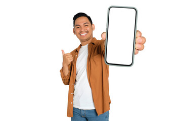 Happy young Asian man in casual shirt showing smartphone with blank screen and thumb up isolated on transparent background