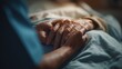 © Nimra - Compassionate hand holding offers comfort and support to an elderly patient receiving healthcare and end of life care.