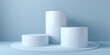 © Petr - Minimalistic 3d white cylindrical podiums on smooth light blue-grey background