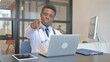 © stockbakers - African Male Doctor Pointing at Camera in Hospital