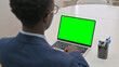 © stockbakers - Overhead View of Young Businessman Using Laptop with Green Screen