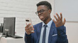 © stockbakers - Young African Man Reacting Angrily to Smartphone Content