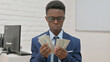 © stockbakers - Portrait of African Man Counting Money