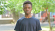 © stockbakers - Casual African Man with Serious Expression Outdoors