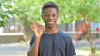 © stockbakers - Casual African Man Making OK Gesture Outdoors