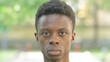 © stockbakers - Close-up of a Serious Young African Man Face