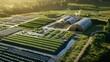 © Mustofa - Aerial view of sustainable agriculture with greenhouses and crops at sunset