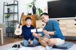 © itchaznong - Back to School Learning. Father and son engaging in educational activities at home.