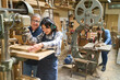 © Robert Kneschke - Young apprentice learning woodwork skills in lumberyard workshop