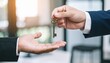© photostockatinat - Close-up shot of hands passing a key, conveying ownership, security and trust. The key is an important object