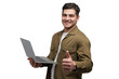 © muse studio - Cheerful young man gives a thumbs up while holding a laptop in a bright studio setting during a productive work session
