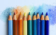 © Ivrin - Colorful crayons on a white background, with a color palette of blue, green, orange, and yellow, showcasing the various shades created by drawing lines with each crayon.
