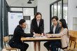 © Wicitr - Collaborative Business Meeting: A focused group of business professionals engaged in an intense meeting, collaborating on a project, conveying professionalism and teamwork.