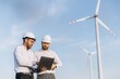 © anatoliycherkas - Engineers using laptop analyzing wind turbine operation