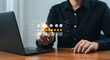 © synthetic - Person giving five star rating on transparent interface over laptop on wooden table surface view