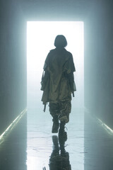 Wall Mural - Back view of a faceless model walking into fog in techwear duster coat, wide tactical pants, combat boots top-down lighting, reflective wet floor, 