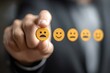 © Oleh - Businessman is making a negative client feedback and choosing a sad face from a rating scale, expressing his dissatisfaction with the provided products or services