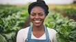 © kirania - Smiling woman posing in a field of lush green agricultural crops