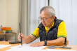 © leungchopan - Senior asian man creating art with brush strokes