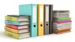 © Saif - A stack of colorful ring binders and loose papers on a white surface.