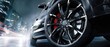 © Studio Nova - The elegant performance car with striking alloy wheels on a city street at night.