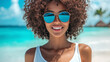 © Ruslan - Smiling African American woman in a fashionable T-shirt and sunglasses standing on a tropical beach with palm trees — summer, freedom and travel