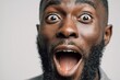 © nisi - Close up photo happy surprised excited face miracle good news amazing rejoice saying wow African American ethnic man open mouth wide surprise male at home insurance loan owner achieve success