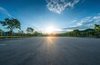 © Fathor - Beautiful, empty asphalt parking lot with a green park landscape background in the morning. Blue sky and sun, captured with a wide-angle lens.