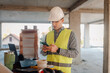 © Ljustina - Construction engineer using smartphone on site, managing projects and staying connected