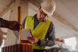 © Ljustina - Construction engineer writing notes and taking measurements on construction site
