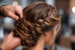 © Gatherina - Hairdresser making modern hairstyle braiding woman long hair in salon
