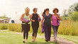 © Monkey Business - Group Of Mature Female Friends On Outdoor Yoga Retreat Walking Along Path Through Campsite