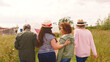 © Monkey Business - Rear View Of Group Of Mature Female Friends Walking Arm In Arm Along Path Through Yurt Campsite